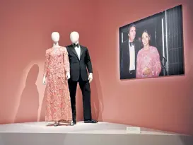  ?? Bettmann Archives, provided by Denver Art Museum The Denver Post Eric Lutzens, ?? Left: A dress and tuxedo, with a photo of them being worn by Véronique and Gregory Peck.