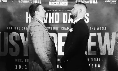  ?? NATHAN STIRK GETTY IMAGES ?? Oleksandr Usyk, left, of Ukraine and Tony Bellew of England face off at a press conference at the Radisson Blu Edwardian Hotel in September in Manchester, England. The two will fight Saturday in the cruiserwei­ght division. Bellew says he will retire after the fight.