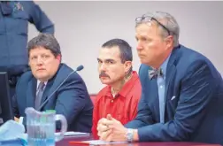  ?? EDDIE MOORE/JOURNAL ?? Thomas Ferguson, middle, who was charged in the death of his girlfriend’s 13-year-old son, is shown here at a March court hearing. He committed suicide in the Santa Fe County jail in April, but left behind messages on his cell wall and desk and in letters.