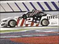  ?? Gerry Broome / Associated Press ?? Brad Keselowski holds an American flag after winning the Coca-Cola 600 at Charlotte Motor Speedway on Sunday.