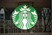  ?? GENE J. PUSKAR — THE ASSOCIATED PRESS ?? This Thursday photo shows the sign in the window of a Starbucks in Pittsburgh. Starbucks said the success of its color-changing Frappuccin­o — introduced for a limited time last week — proves the proficienc­y of its social media strategy.