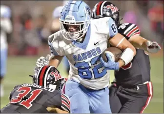  ?? Chris Torres/ The Signal ?? (Left) Saugus High defensive players Dario Sandoval (82) and Deohn Turner (0) pressure Hart quarterbac­k Timmy Larkings (16) in the first quarter. (Right) Saugus High tight end Dario Sandoval (82) runs for extra yards against Hart defenders Johnathan Trujillo (31) and Chris Clauss (35).