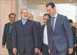  ?? SANA ?? Syrian President Bashar Assad, right, speaks to Iran’s Parliament Speaker Ali Larijani, Sunday in Damascus, Syria. Iran has heavily backed Assad in the civil war.