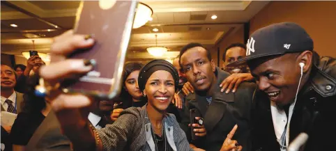  ?? (Reuters) ?? DEMOCRATIC CONGRESSIO­NAL candidate Ilhan Omar takes a selfie with supporters after appearing at her election party.