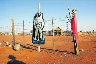  ??  ?? RELATIVE COMFORT: A Khwe homestead, Platfontei­n, about 15km from Kimberley in South Africa, 2013. Platfontei­n had brick houses and every home had a tap and an outside toilet, which made it more desirable than the depressing tent town of Schmidtsdr­ift