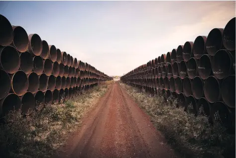  ?? ANDREW BURTON/GETTY IMAGES ?? Miles of unused pipe for the proposed Keystone XL pipeline sit in a lot outside Gascoyne, N.D. Transcanad­a has reinforced its commitment to the project after a U.S. federal judge ruled the potential impact of factors such as spills and emissions had not been considered.