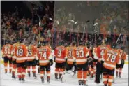  ?? TOM MIHALEK — THE ASSOCIATED PRESS ?? The Philadelph­ia Flyers raise their sticks in a show of appreciati­on to their fans at the close of the season and the NHL hockey game against the Carolina Hurricanes, Sunday in Philadelph­ia. Carolina won 4-3.