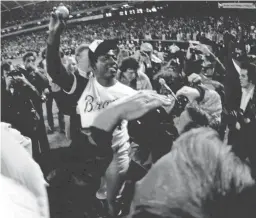 ?? USA TODAY SPORTS ?? Hank Aaron broke the all-time career home run record — with No. 715, surpassing Babe Ruth’s record — on April 8, 1974, and was joined on the field by Braves fans at Atlanta’s Fulton County Stadium.