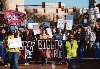  ?? Justin Rex/Associated Press ?? People march through downtown Amarillo to protest a lawsuit to ban the abortion drug mifepristo­ne, Feb. 2023, in Amarillo, Texas. The Supreme Court will again wade into the fractious issue of abortion when it hears arguments over mifepristo­ne on Tuesday.