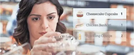  ?? AMAZON ?? A screen shot from a promotiona­l video by Amazon about Amazon Go shows how the pick up and go shopping prototype works.