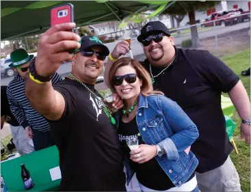  ?? RECORDER PHOTOS BY CHIEKO HARA ?? Rigo Lucio, left, takes a selfie with Diane Cerbantes and Abe Jiron, right, Saturday, March 17, at the annual Portervill­e Lions Club's St. Patrick's Day Brewfest.