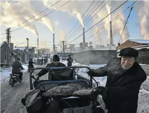  ?? Picture: Kevin Frayer/Getty Images ?? Smoke billows from stacks in a neighbourh­ood next to a coal-fired power plant in Shanxi, China. Coaladdict­ed SA is the 11th-highest emitter of carbon emissions in the world.