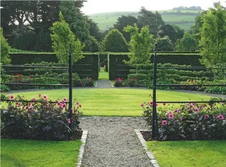  ??  ?? Above: A circular lawn at the centre of the Pear Garden, where espaliered pears are underplant­ed with tulips in spring and dahlias in summer