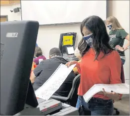  ?? ALICIA FABBRE/DAILY SOUTHTOWN ?? Will County Clerk Lauren Staley-Ferry feeds a ballot into a tabulator during the Oct. 10 central count of mail-in ballots.