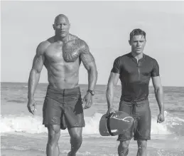  ?? Paramount Pictures ?? Dwayne Johnson stars as Mitch Buchannon, left, and Zac Efron as Matt Brody in "Baywatch."