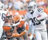  ?? KEN BLAZE, USA TODAY SPORTS ?? Raiders receiver Amari Cooper stiffarms the Browns’ Tank Carder on one of his eight receptions for 134 yards last week.