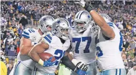  ?? DON WRIGHT/ASSOCIATED PRESS ?? Cowboys running back Ezekiel Elliott, second from left, celebrates his game-winning touchdown with offensive linemen Travis Frederick, left, Tyron Smith and Ronald Leary.