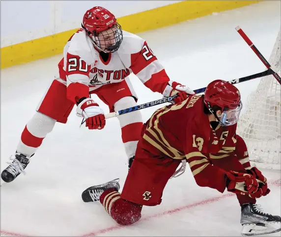  ?? MATT STONE — BOSTON HERALD ?? Lane Hutson (20) of Boston University shoves Nikita Nesterenko of Boston College during the third period of the consolatio­n round of the Beanpot at the TD Garden on Jan. 13 in Boston. The Terriers will play Friday at 4 p.m. in a Hockey East semifinal.
