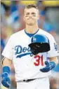  ?? Stephen Dunn Getty Images ?? JOC PEDERSON heads for the dugout after being called out on strikes in the seventh inning.