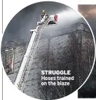  ??  ?? STRUGGLE Hoses trained on the blaze