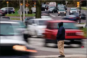  ?? ?? A pedestrian waits April 19 to cross Roosevelt Boulevard.
(AP/Matt Rourke)