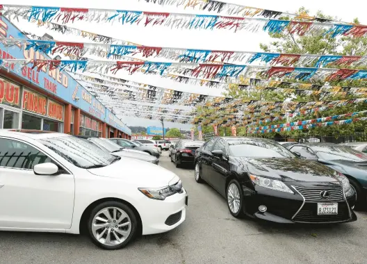  ?? JUSTIN SULLIVAN/GETTY 2022 ?? Used cars for sale are displayed on a lot in Richmond, California. You might find more cars on lots this year, but the inventory may not be as high as it once was.