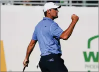  ?? DARRYL WEBB — THE ASSOCIATED PRESS ?? Scottie Scheffler pumps his fist after making par on the 16th hole during his final-round 65 Sunday to win the Phoenix Open.