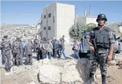  ?? REUTERS ?? Security forces gather near a damaged building at the city of Salt, Jordan, yesterday.