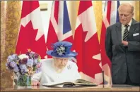  ?? STEFAN ROUSSEAU/PA VIA AP ?? Britain’s Queen Elizabeth II, accompanie­d by the Duke of Edinburgh, sign the visitor’s book at Canada House in Trafalgar Square, central London, July 19, marking the 150th anniversar­y of Canada’s Confederat­ion.