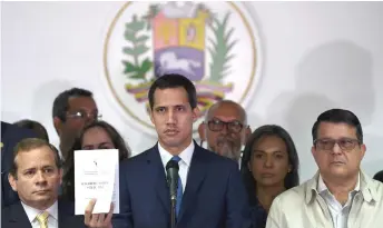  ?? Photo — AFP ?? Guaido (centre) gestures during a press conference a day after a controvers­ial parliament voting, in Caracas.