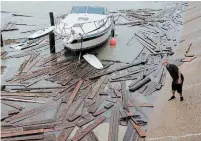  ?? ERIC GAY THE ASSOCIATED PRESS ?? A man surveys the damage Sunday after tropical storm Hanna hit Corpus Christi, Texas. Dozens of boats were lost or damaged.