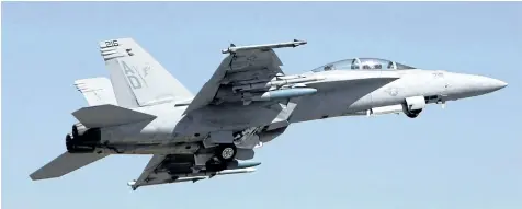  ?? THE ASSOCIATED PRESS FILES ?? A U.S. Air Force F-18 Super Hornet fighter aircraft takes off at the opening ceremony of Aero India 2011 in Yelahanka air base on the outskirts of Bangalore, India on Feb. 9, 2011. Boeing is weighing in on the Trudeau government’s plan to buy used...