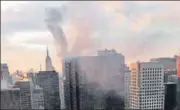  ?? AP ?? Smoke rises from Trump Tower in New York on Monday. Two civilians and a firefighte­r were injured in a fire that started in the heating and air conditioni­ng system of the building.