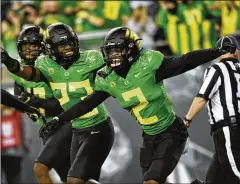  ?? ANDY NELSON/AP ?? Oregon cornerback Mykael Wright (2) celebrates his intercepti­on during the first quarter of the Ducks’ win over Arizona in Eugene.