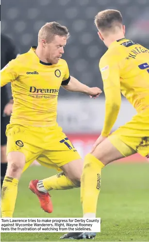  ??  ?? Tom Lawrence tries to make progress for Derby County against Wycombe Wanderers. Right, Wayne Rooney feels the frustratio­n of watching from the sidelines.