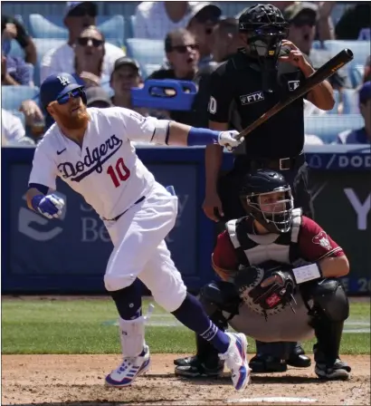  ?? MARK J. TERRILL — THE ASSOCIATED PRESS ?? Justin Turner watches his three-run homer in the fourth inning Wednesday that gave the Dodgers a 4-2lead over Arizona at Dodger Stadium.
