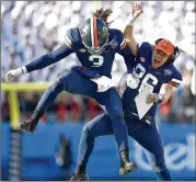  ?? GRANT HALVERSON / GETTY IMAGES ?? Virginia’s Bryce Perkins (left) celebrates with Lindell Stone after throwing a fourth quarter touchdown against South Carolina during the Belk Bowl in Charlotte. Virginia won 28-0.