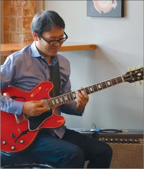  ?? NEWS PHOTO MO CRANKER ?? Jazz guitarist Nobuki Takamen plays part of his two-hour set Thursday afternoon at Station Street Coffee Co. This year’s Jazzfest is Takamen's fifth in Medicine Hat, and he says it is one of his favourite festivals to take part in.