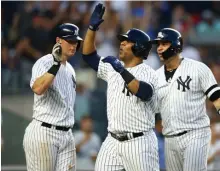  ?? GETTY IMAGES ?? RISING UP: Edwin Encarnacio­n celebrates his grand slam with Yankees’ D.J. LeMahieu (left) and Gary Sanchez.