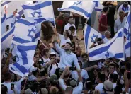  ?? (AP/Mahmoud Illean) ?? Israeli Knesset member Bezalel Smotrich (center) waves an Israeli flag with other Jewish ultranatio­nalists Tuesday outside Jerusalem’s Old City during the “Flags March.”