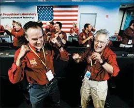  ?? AL SEIB/LOS ANGELES TIMES ?? NASA engineers Kris Bruvold, left, and Sandy Krasner celebrate after InSight landed.
