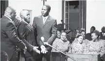  ??  ?? Three male members of the University Singers. Franklin Halliburto­n (left), Kester Bailey (centre) and Anthony Alexander amuse other Singers at the Philharmon­ic Orchestra of Jamaica concert, held last Saturday at the University Chapel, Mona.