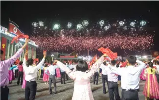  ?? AFP PHOTO ?? CELEBRATIO­N In a photo taken on Sunday participan­ts described as ‘working people, youth, and students of Pyongyang’ watch fireworks as they perform during a mass gala event marking the 20th anniversar­y of late North Korean leader Kim Jong Il’s election...