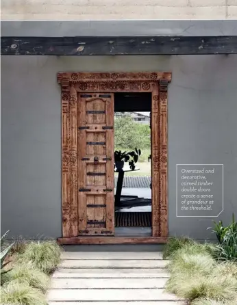  ??  ?? Oversized and decorative, carved timber double doors create a sense of grandeur at the threshold.