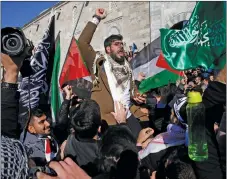  ?? "1 1)050 ?? Protesters chant anti-U.S. slogans as they march in the streets after Friday prayers in Istanbul.