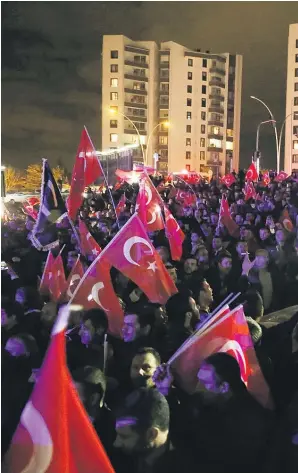  ??  ?? Protesters wave Turkish flags as they stage a demonstrat­ion outside the
