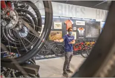  ?? Bobby Block/The Signal ?? Alasdair Fraser, store manager for the new Saugus location of Trek Bicycle, discusses a display Monday morning, opening day for the store tailored toward high-end mountain bikes.