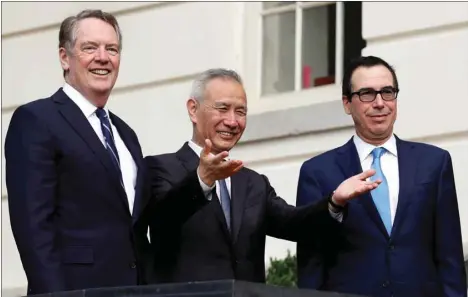  ??  ?? China’s Vice Premier Liu He gestures to the media between US Trade Representa­tive Robert Lighthizer (left) and Treasury Secretary Steve Mnuchin before the two countries’ trade negotiatio­ns in Washington yesterday. The currency accord, which the US said had been agreed to earlier this year before trade talks broke down, would be part of what the White House considers to be a first-phase agreement with Beijing.