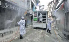  ?? WASEEM ANDRABI/HT ?? Municipal corporatio­n employees disinfect the Dal Gate area of Srinagar on Monday.