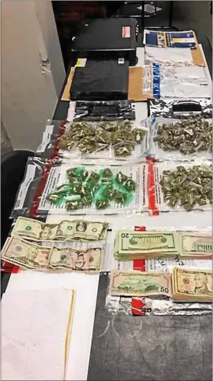  ?? TROY POLICE DEPARTMENT ?? Police arrested nine people and seized marijuana, cocaine and cash after simultaneo­us Thursday night raids on nine homes in Troy’s North Central neighborho­od.